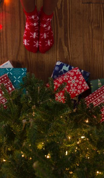 gifts, Christmas tree, holidays, feet, socks, bright light bulbs Wallpaper 600x1024
