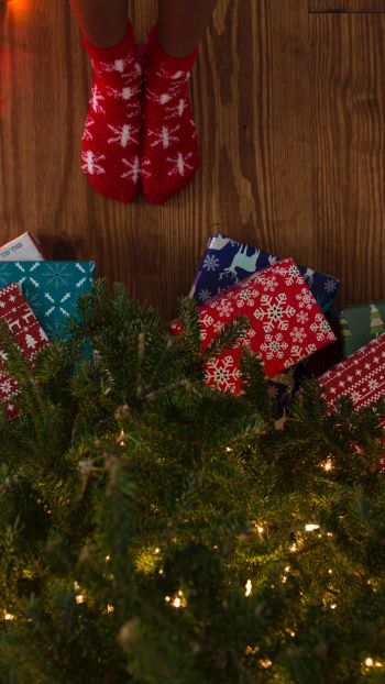 Обои 1080x1920 подарки, елка, праздники, ноги, носки, яркие лампочки