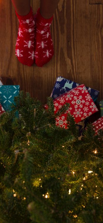 gifts, Christmas tree, holidays, feet, socks, bright light bulbs Wallpaper 1284x2778