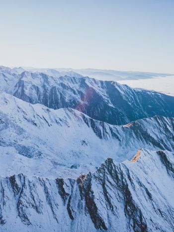 Обои 1668x2224 снег в горах, горы, зима, вид с дрона