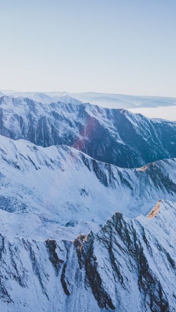 snow in the mountains, mountains, winter, drone view Wallpaper 640x1136