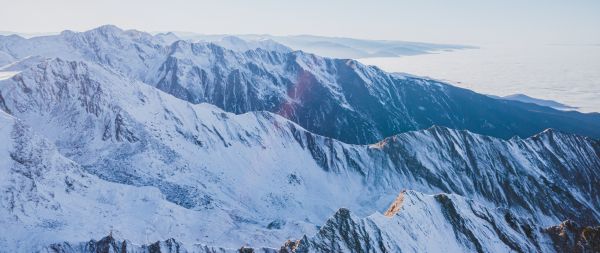 snow in the mountains, mountains, winter, drone view Wallpaper 2560x1080