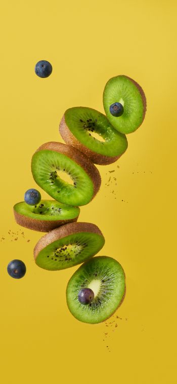 kiwi, blueberry, yellow background Wallpaper 1080x2340