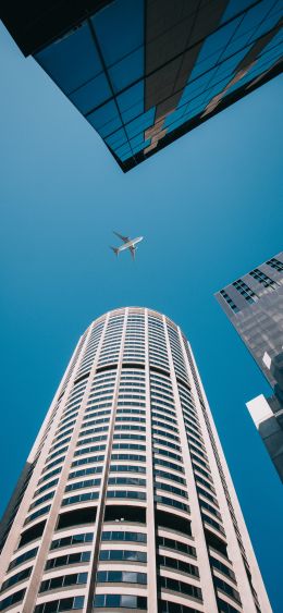 plane, buildings, height Wallpaper 1080x2340