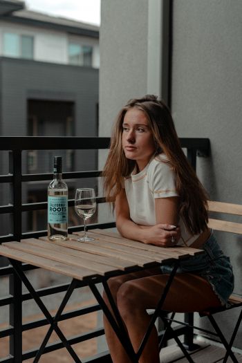 girl, balcony, bottle of wine Wallpaper 640x960