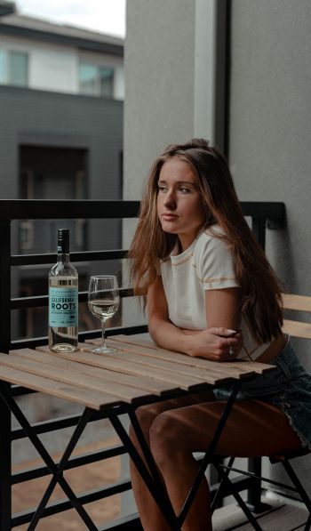 girl, balcony, bottle of wine Wallpaper 600x1024