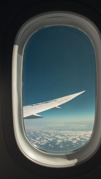 airplane wing, window view Wallpaper 750x1334