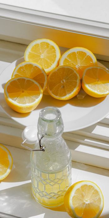 bottle, lemons Wallpaper 720x1440