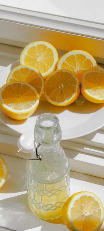 bottle, lemons Wallpaper 720x1600